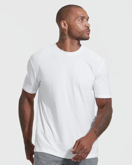 Man wearing The Standard Active Crew Neck T-Shirt, looking sideways.