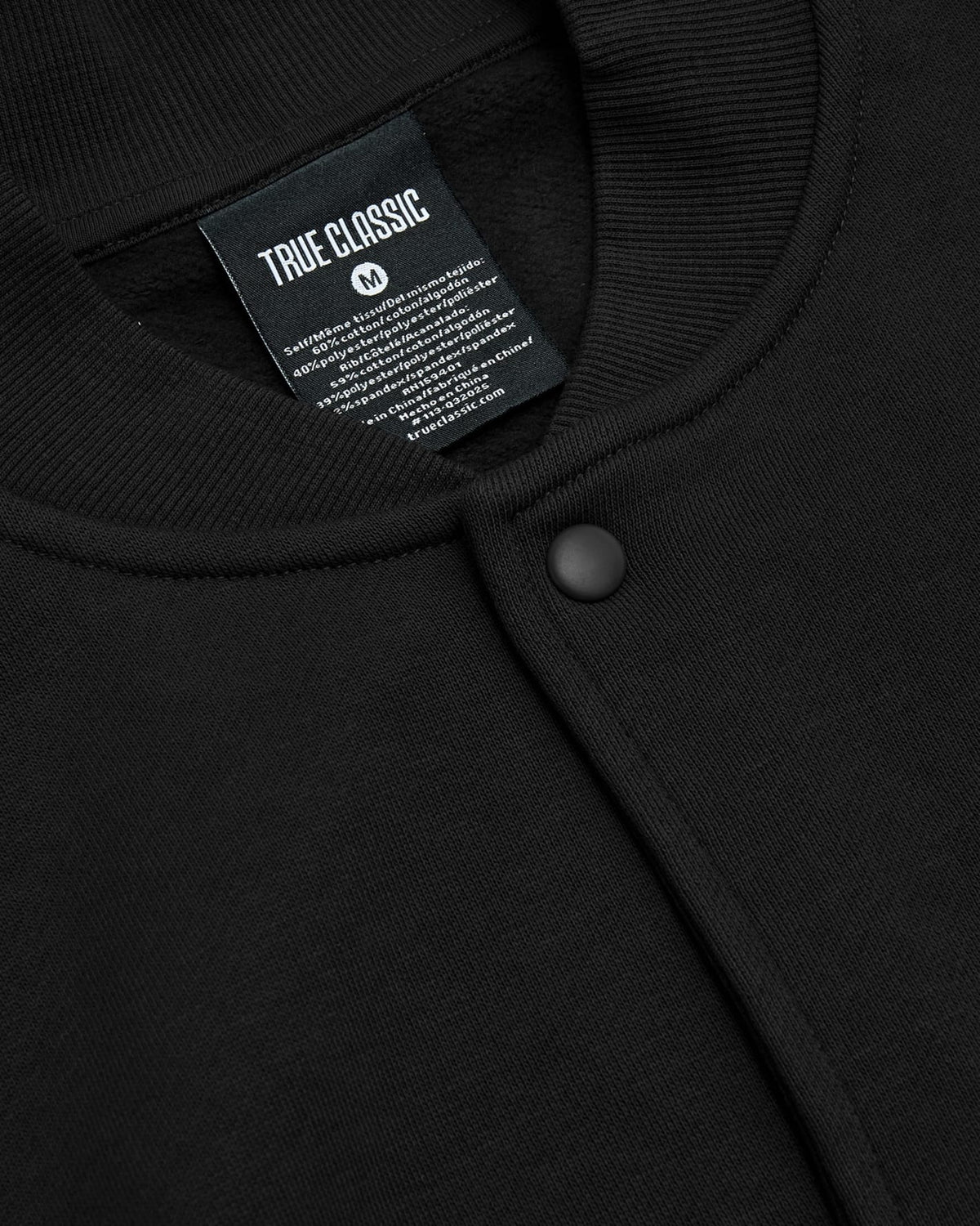 Black Fleece Bomber Jacket, close-up of collar, snap-buttons, True Classictees tag.