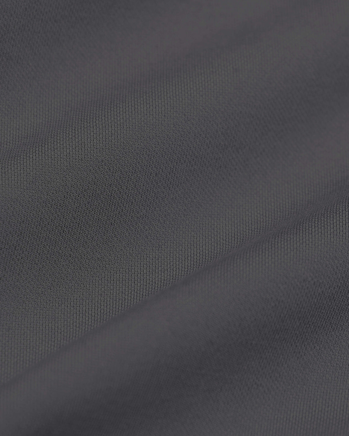 Carbon Commuter Pants close-up, showcasing dark gray woven texture.