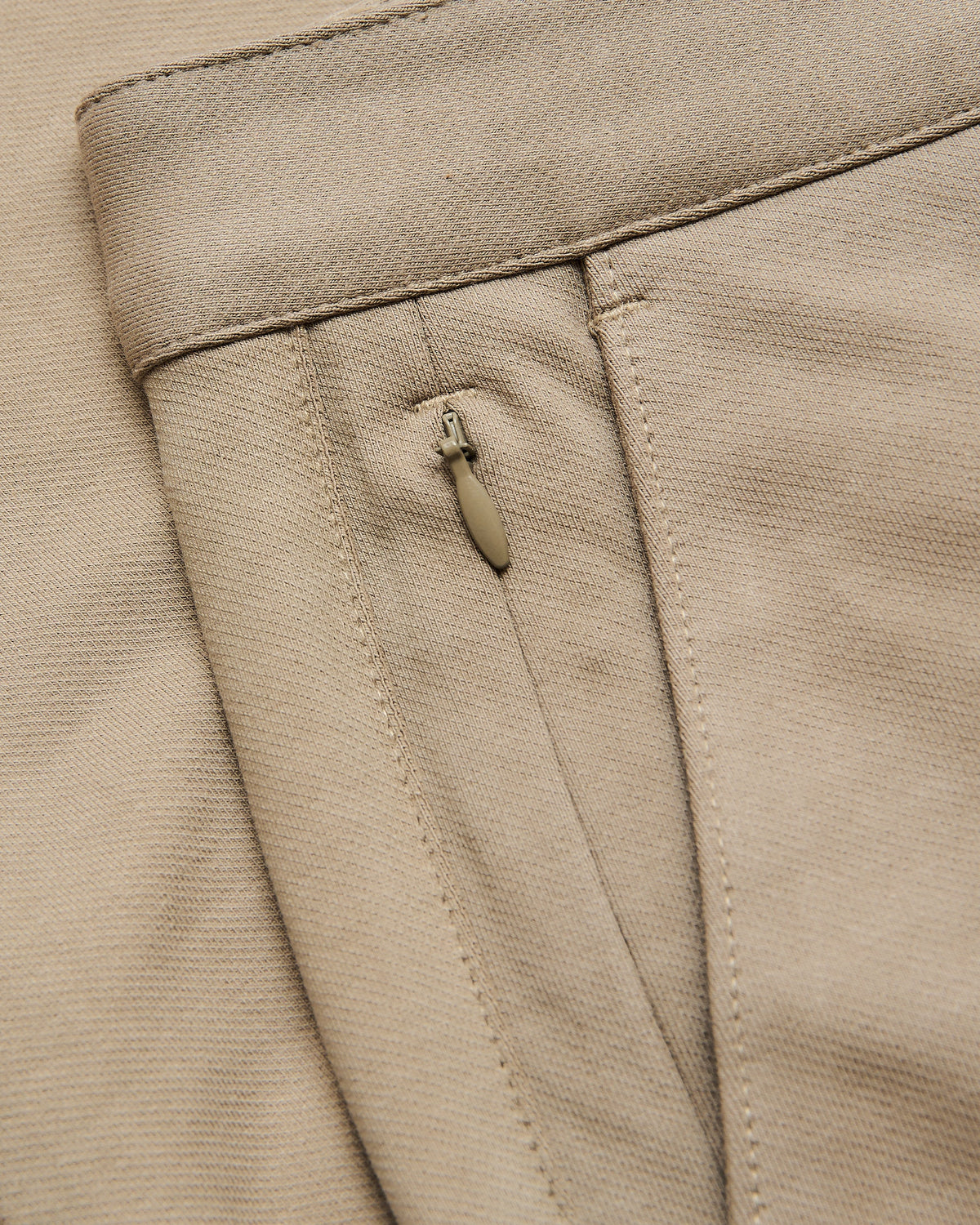 Core Slim Chino Pants waistband with stitching and hidden zip pocket.