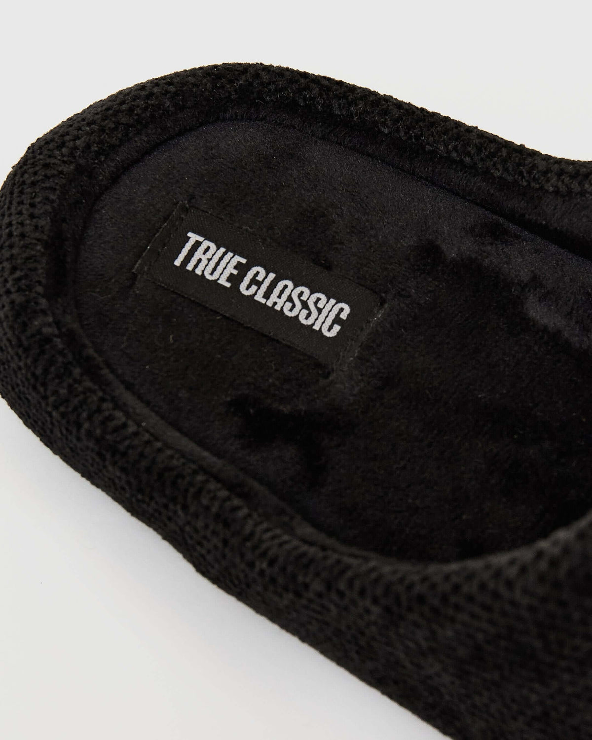 Black Slippers with knit-and-fleece headband, True Classictees label visible.