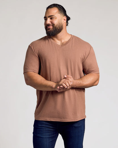 Man in Dark Heather Sepia Classic V-Neck, relaxed pose.