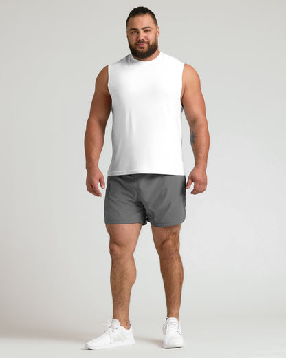 Man in White Sleeveless Active Muscle Tee, gray shorts, white sneakers.