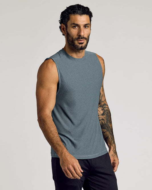 Man wearing a heather navy Sleeveless Active Muscle Tee 3-Pack, showcasing a sleeveless, fitted muscle tee in a soft, breathable fabric for men's active basics.