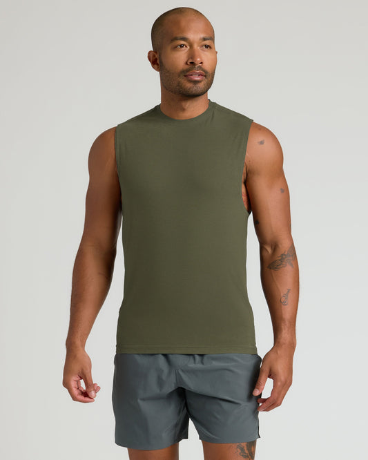Man wearing Limited Sleeveless Active Muscle Tee in olive, showcasing tattoos and fit.