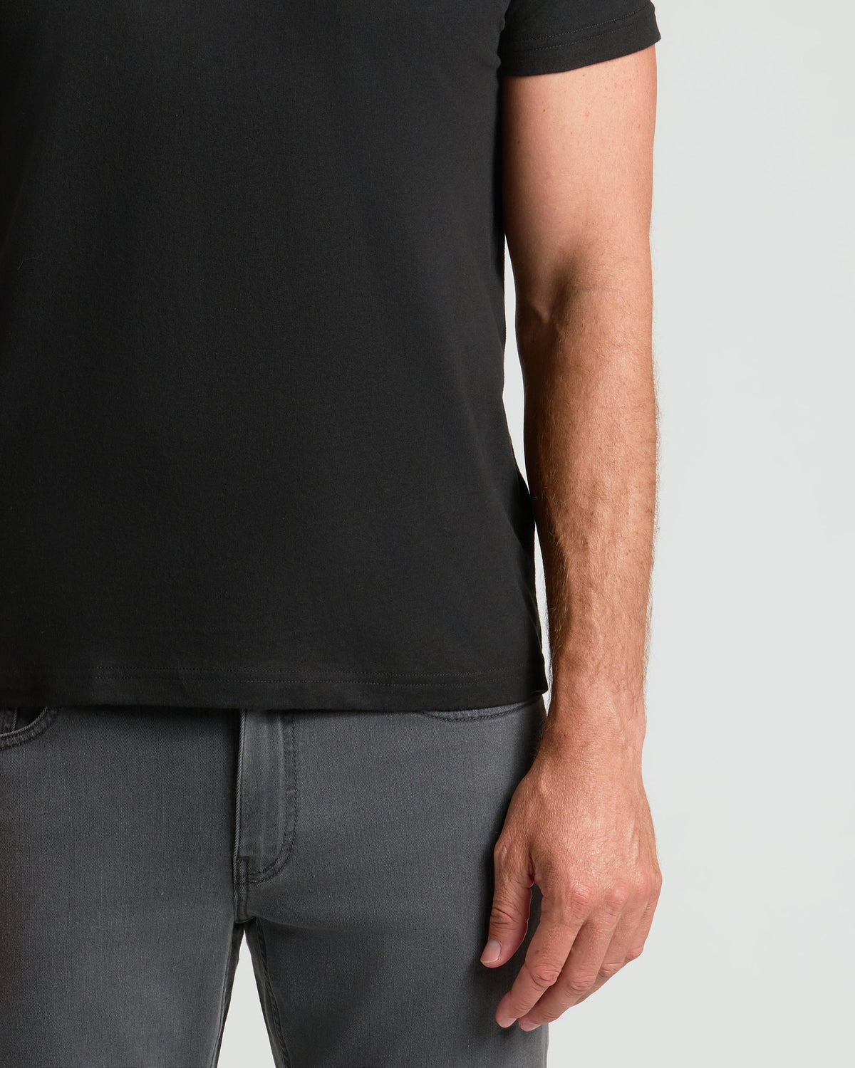 Black classic crew neck T-shirt on model with short sleeves and regular fit.