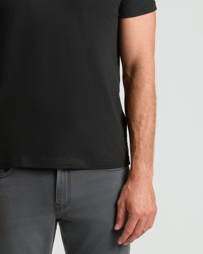 Black classic crew neck T-shirt on model with short sleeves and regular fit.