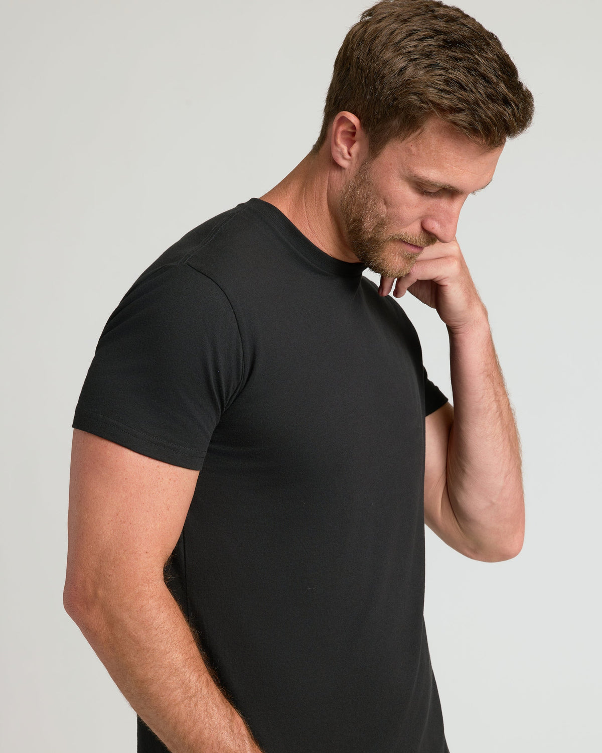 Black short-sleeve crew neck t-shirt on male model, fitted style.