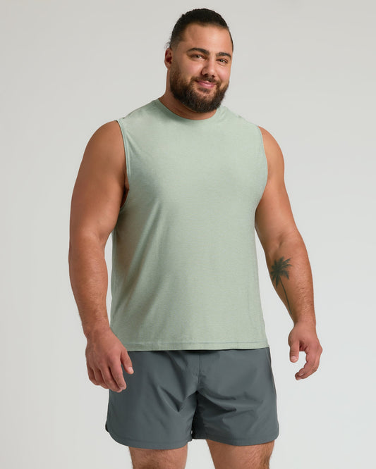 Man wearing Lichen Sleeveless Active Muscle Tee and dark gray shorts.