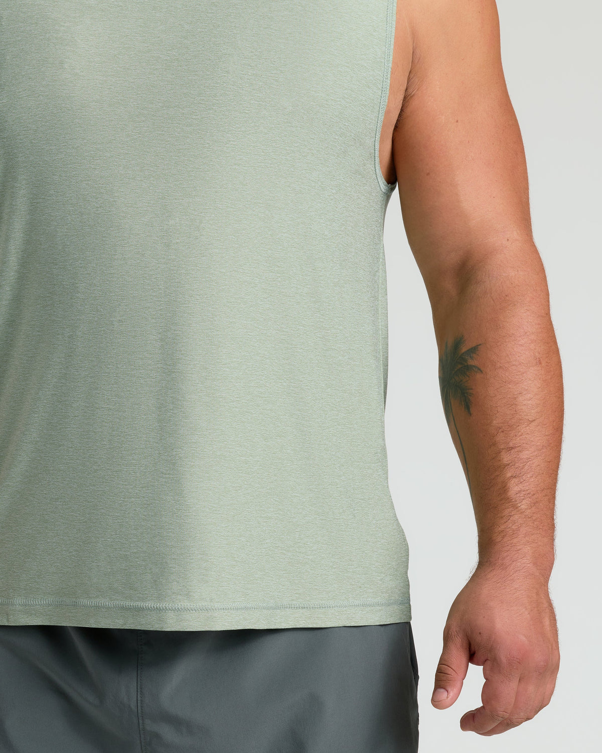 Lichen Sleeveless Active Muscle Tee worn with dark gray shorts.