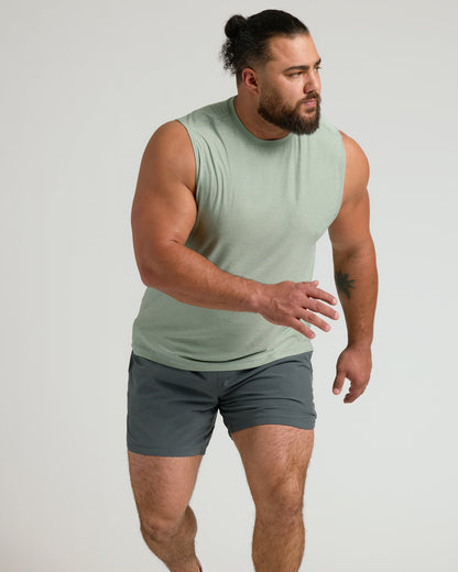 Muscular man wearing Lichen Sleeveless Active Muscle Tee in athletic pose.