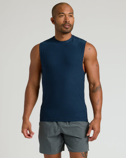 Man in Dark Heather Navy Sleeveless Active Muscle Tee, relaxed pose.