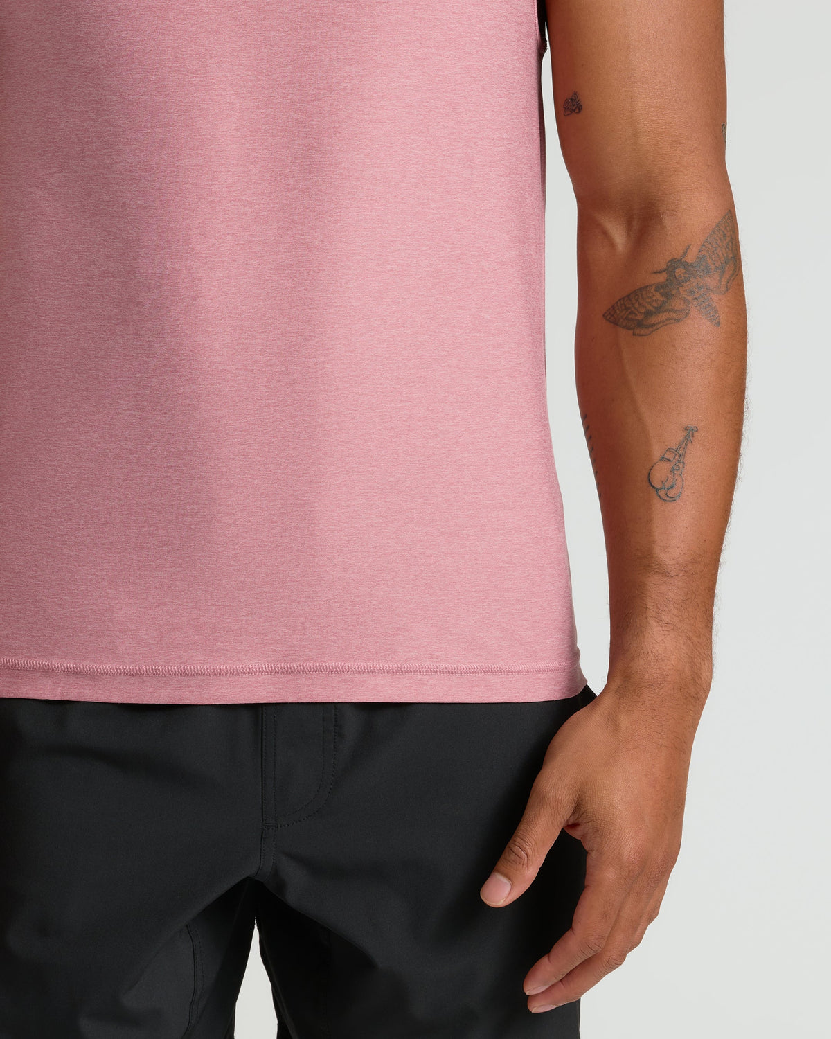 Quartz Rose Sleeveless Active Muscle Tee showcased on a tattooed forearm.